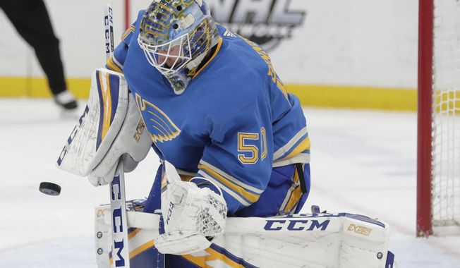 St. Louis Blues goaltender Jordan Binnington (50) makes a stick-save in the first period of an NHL hockey game against the Tampa Bay Lightning, Saturday, March 23, 2019, in St. Louis. (AP Photo/Tom Gannam)