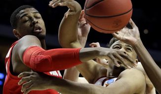 Ohio State&#x27;s Keyshawn Woods, left, and Iowa State&#x27;s Nick Weiler-Babb battle for a rebound during the first half of a first round men&#x27;s college basketball game in the NCAA Tournament Friday, March 22, 2019, in Tulsa, Okla. (AP Photo/Charlie Riedel)