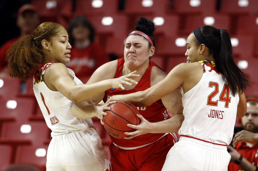 Maryland forwards Shakira Austin, left, and Stephanie Jones, right, pressure Radford center Sydney Nunley as Nunley tries to keep possession of the ball in the first half of a first round women's college basketball game in the NCAA Tournament, Saturday, March 23, 2019, in College Park, Md. (AP Photo/Patrick Semansky)