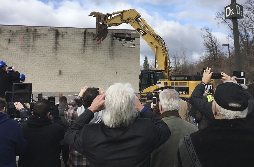 FILE - In this March 5, 2018 file photo, people take pictures during a ceremony in East Windsor, Conn., marking the start of demolition of a movie theater at the site of what they hope will be a new casino that the Mashantucket Pequot and the Mohegan tribes would operate jointly. Construction has not yet started a year later. The U.S. Department of Interior may have finally given the go-ahead to the planned satellite casino at the site, but that doesn't mean the debate over gambling in Connecticut is settled. (AP Photo/Susan Haigh, File)