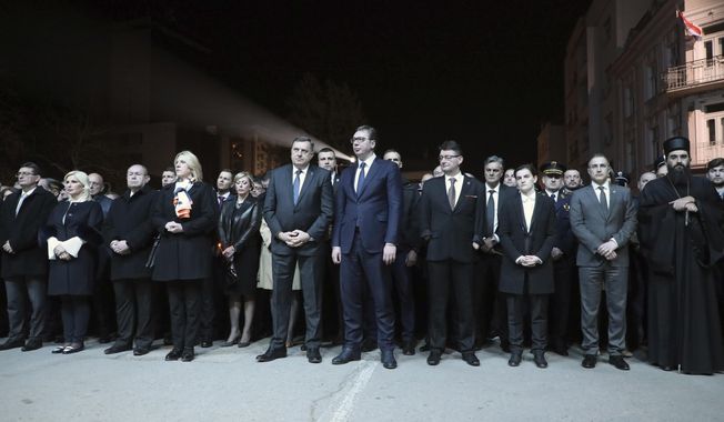 In this photo provided by the Serbian government, Serbian President Aleksandar Vucic, centre, along with other dignitaries, attend a remembrance ceremony to mark the twentieth anniversary of the 1999 NATO intervention, in Nis, Serbia, Sunday, March 24, 2019.  Twenty years after NATO intervened to stop Serbia&#x27;s onslaught in Kosovo, Belgrade on Sunday commemorated the victims of what it says was an aggression while Kosovo hailed the beginning of its national liberation. (Serbian Government via AP)