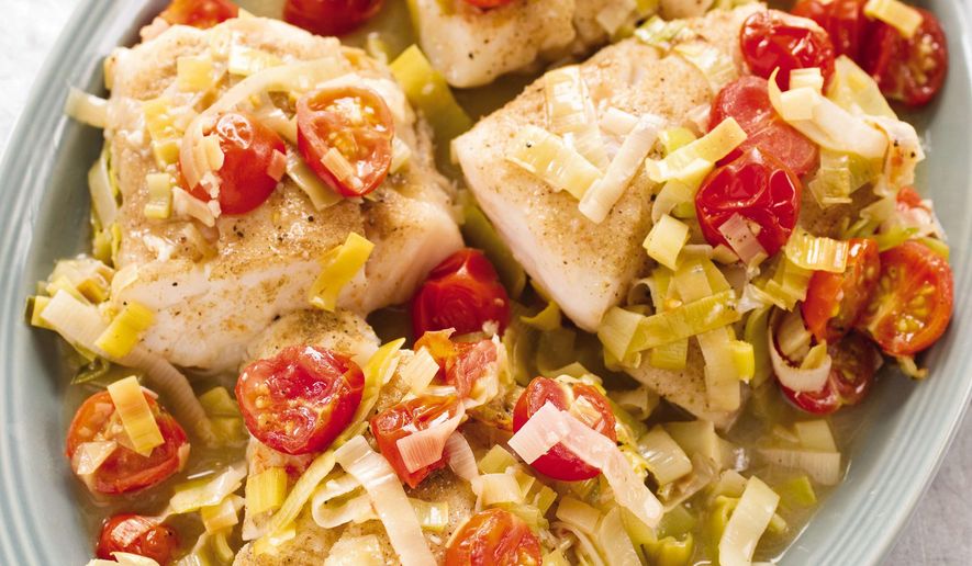 This undated photo provided by America's Test Kitchen in March 2019 shows Braised Cod With Leeks in Brookline, Mass. This recipe appears in the cookbook "How to Braise Everything." (Daniel J. van Ackere/America's Test Kitchen via AP)