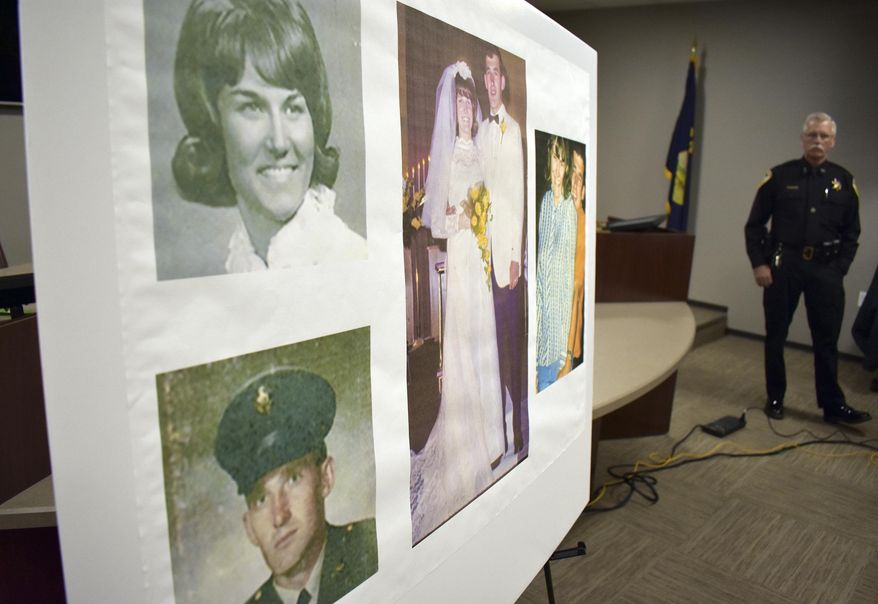 Photos of Linda and Clifford Bernhardt, who were killed in 1973, are displayed at a press conference at the Yellowstone County administrative offices in Billings, Montana on Monday, March 25, 2019. Yellowstone County Sheriff Mike Linder, pictured at right, says authorities have identified the couple's now-deceased killer. (AP Photo/Matthew Brown)