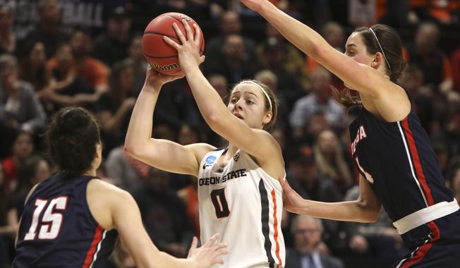 Oregon State&#x27;s Mikayla Pivec (0) looks for a way through Gonzaga&#x27;s Jessie Loera (15) and LeeAnne Wirth (4) during the first half of a second-round game of the NCAA women&#x27;s college basketball tournament in Corvallis, Ore., Monday, March 25, 2019. (AP Photo/Amanda Loman)