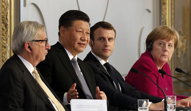 French President Emmanuel Macron, 2nd right, Chinese President Xi Jinping, German Chancellor Angela Merkel and European Commission President Jean-Claude Juncker, left, hold a press conference at the Elysee presidential palace in Paris, Tuesday, March 26, 2019. Xi Jinping is meeting with the leaders of France, Germany and the European Commission, as European countries seek to boost relations with China while also putting pressure over its trade practices. (AP Photo/Thibault Camus, Pool) **FILE**