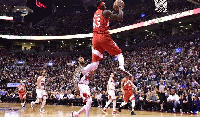 Toronto Raptors forward Pascal Siakam (43) scores as Chicago Bulls guard Wayne Selden (14) looks on during the second half of an NBA basketball game in Toronto on Tuesday, March 26, 2019. (Frank Gunn/The Canadian Press via AP)