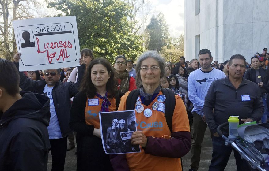 Immigrant rights advocates rally outside the Oregon state Capitol in favor of a measure that would expand driver's license access to undocumented immigrants Tuesday, March 26, 2019, in Salem, Ore. Oregon lawmakers are considering the change as it prepares to overhaul its state identification system in compliance with federal law. (AP Photo/Sarah Zimmerman)