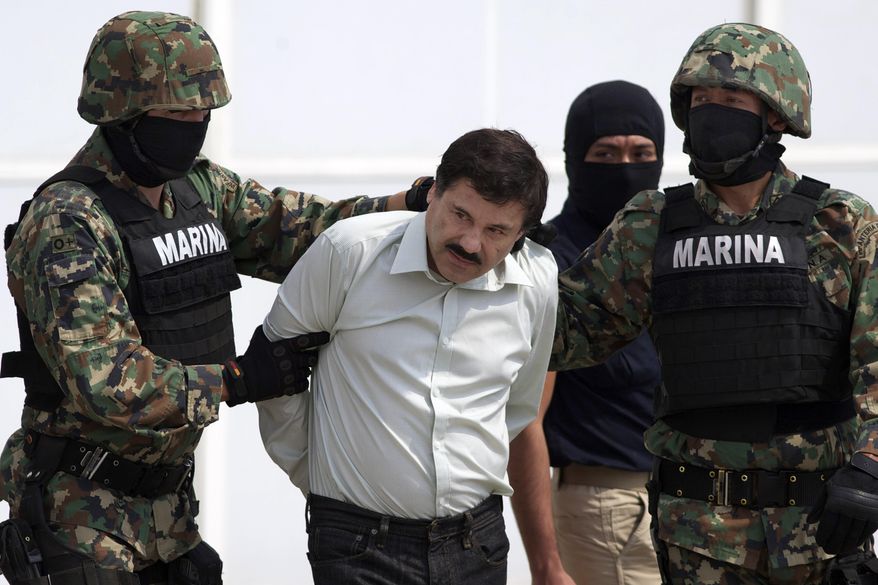 FILE - In this Feb. 22, 2014 file photo, Joaquin "El Chapo" Guzman, center, is escorted to a helicopter in handcuffs by Mexican navy marines at a hanger in Mexico City, after he was captured overnight in the beach resort town of Mazatlan. Defense attorneys asked a federal judge Tuesday, March 26, 2019, to grant a new trial to El Chapo, saying jurors improperly followed media coverage of the sensational drug conspiracy case. (AP Photo/Eduardo Verdugo, File)