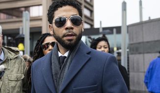 Empire actor Jussie Smollett, leaves the Leighton Criminal Court Building after his hearing on Thursday, March 14, 2019, in Chicago. Smollett pleaded not guilty to charges accusing him of lying to police about being attacked in downtown Chicago a few weeks ago. (Ashlee Rezin/Sun-Times/Chicago Sun-Times via AP)