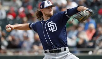 FILE - In this March 8, 2019, file photo, San Diego Padres pitcher Chris Paddack throws against the Oakland Athletics during the first inning of a spring training baseball game, in Mesa, Ariz. The 23-year-old Paddack, a promising right-hander, will be part of San Diego’s rotation when the regular season begins. (AP Photo/Matt York, File)