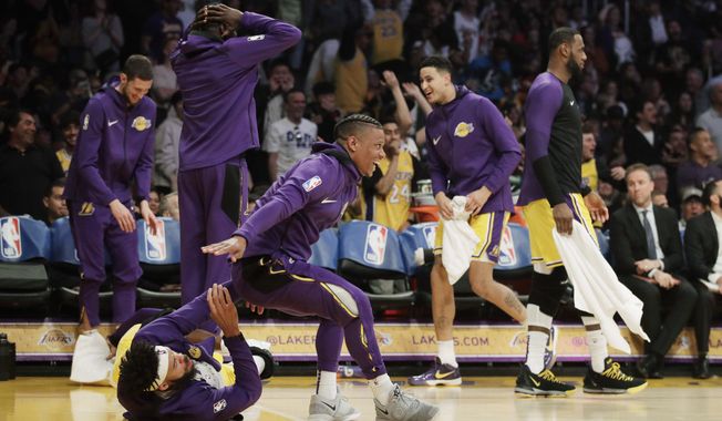 The Los Angeles Lakers bench reacts after Lance Stephenson pulled an ankle breaker on Washington Wizards' Jeff Green during the first half of an NBA basketball game, Tuesday, March 26, 2019, in Los Angeles. (AP Photo/Jae C. Hong)