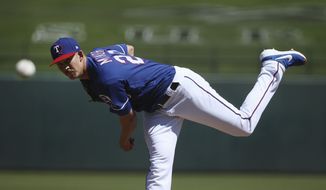 Texas Rangers pitcher Mike Minor throws against the Milwaukee Brewers during the first inning of a spring training baseball game Saturday, March 23, 2019, in Surprise, Ariz. (AP Photo/Ross D. Franklin)