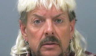 FILE - This file photo provided by the Santa Rose County Jail in Milton, Fla., shows Joseph Maldonado-Passage. Prosecutors say Maldonado-Passage, also known as &amp;quot;Joe Exotic, tried to arrange the killing of Carole Baskin, the founder of Big Cat Rescue. Lurors were shown a Facebook video Tuesday, March 26, 2019,  that depicts Maldonado-Passage shooting a blow-up &amp;quot;Carole&amp;quot; doll in the head. Other videos show him pretending to dig a grave for Baskin and threatening to mail her rattlesnakes. (Santa Rosa County Jail via AP, File)