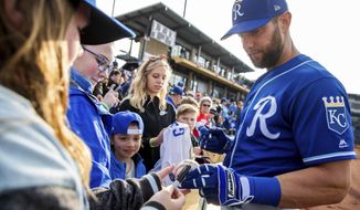 Kansas City Royals&#39; Alex Gordon gives autographs to fans prior to an exhibition baseball game against the Omaha Storm Chasers at Werner Park in Papillion, Neb., Monday, March 25, 2019. (Brendan Sullivan/Omaha World-Herald via AP)