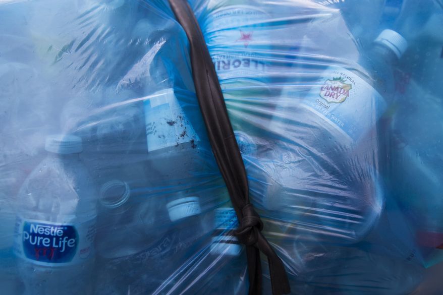 Plastic water bottles are seen bundled up in a bag belonging to a person who collect bottles for the refund, Wednesday, March 27, 2019, in New York. Two New York lawmakers say Wednesday that they're optimistic that a ban on single-use plastic shopping bags could be included in the spending plan that's due Sunday. (AP Photo/Mary Altaffer)