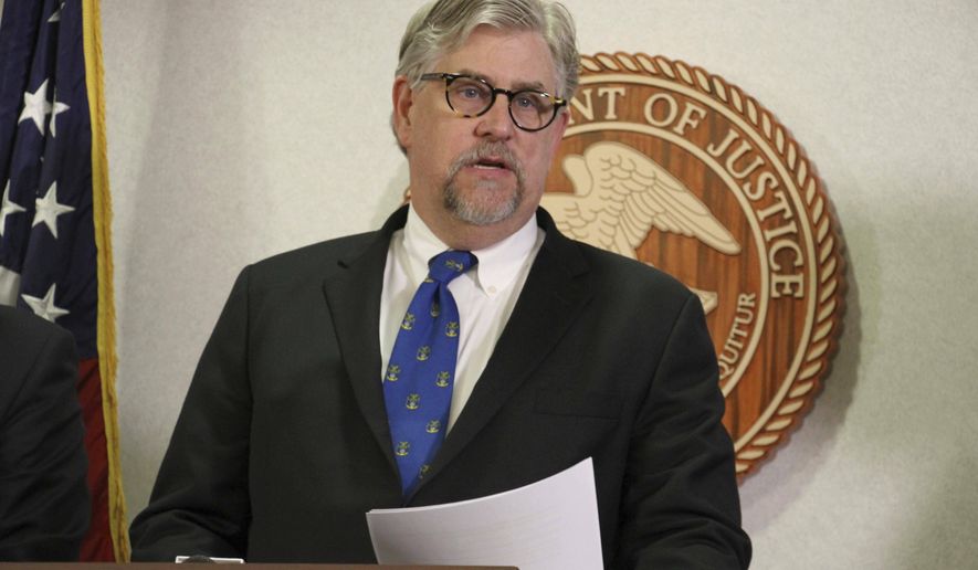 Bryan Schroder, Alaska's U.S. Attorney announces that several members of a white supremacist gang operating in Alaska prisons or shipped to facilities in Colorado and Arizona, have been charged in a racketing enterprise in Anchorage, Alaska, Wednesday, March 27, 2019. Members who sport Nazi tattoos face racketeering charges including murder, kidnapping, assault, and distribution of narcotics and firearms. (AP Photo/Mark Thiessen)