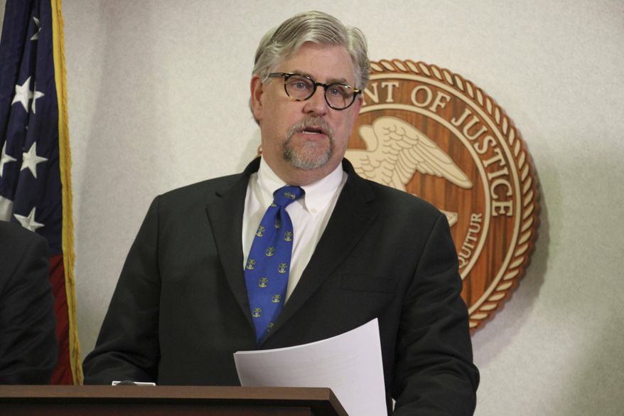 Bryan Schroder, Alaska's U.S. Attorney announces that several members of a white supremacist gang operating in Alaska prisons or shipped to facilities in Colorado and Arizona, have been charged in a racketing enterprise in Anchorage, Alaska, Wednesday, March 27, 2019. Members who sport Nazi tattoos face racketeering charges including murder, kidnapping, assault, and distribution of narcotics and firearms. (AP Photo/Mark Thiessen)