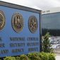 In this June 6, 2013, file photo, vehicles are parked near a sign outside the National Security Agency campus in Fort Meade, Md. (AP Photo/Patrick Semansky, File) 