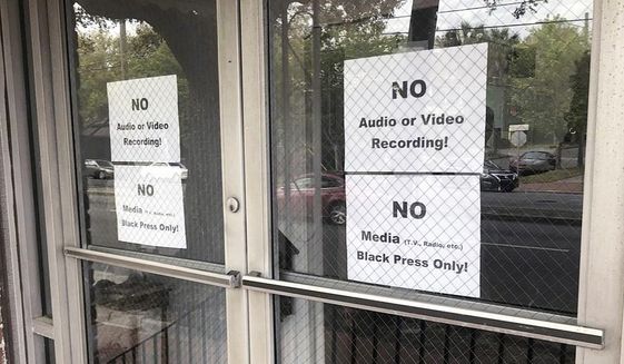 In this Wednesday, March 27, 2019 photo, signs posted on the doors of the Bolten Street Baptist Church are seen during a meeting coordinated to garner support for one black candidate in Savannah&#39;s mayoral race, in Savannah, Ga. Organizers of a meeting to discuss an upcoming mayoral race in Georgia barred reporters from attending, unless they were African-American. (Eric Curl/Savannah Morning News via AP)