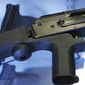 In this Oct. 4, 2017, photo, a device called a &quot;bump stock&quot; is attached to a semi-automatic rifle at the Gun Vault store and shooting range in South Jordan, Utah. In the days and weeks leading up to the ban on bump stocks that took effect Tuesday, March 26, 2019, tens of thousands of the devices were destroyed by owners or handed over to authorities. (AP Photo/Rick Bowmer) **FILE**