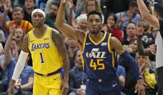Utah Jazz guard Donovan Mitchell (45) celebrates after scoring 3-pointer against Los Angeles Lakers guard Kentavious Caldwell-Pope (1) during the first half of an NBA basketball game Wednesday, March 27, 2019, in Salt Lake City. (AP Photo/Rick Bowmer)