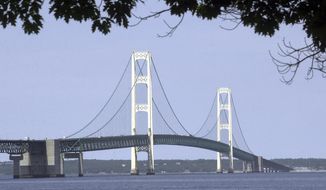 FILE - In this July 19, 2002 file photo, the Mackinac Bridge that spans the Straits of Mackinac is shown from Mackinaw City, Mich. Michigan Gov. Gretchen Whitmer has ordered state departments and agencies to take no further action on legislation enacted in late 2018 authorizing construction of an oil pipeline tunnel beneath lakes Huron and Michigan. On Thursday, March 28, 2019, Michigan Attorney General Dana Nessel, deemed unconstitutional a 2018 law that established a panel to oversee construction and operation of an oil pipeline tunnel beneath the channel linking Lakes Huron and Michigan. (AP Photo/Carlos Osorio, File)