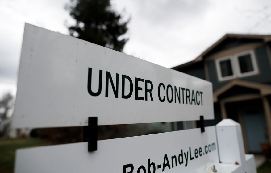 FILE- In this March 28, 2018, file photo an under contract sign is shown outside a single-family home on the market in Denver. On Thursday, March 28, 2019, the National Association of Realtors releases its February report on pending home sales, which are seen as a barometer of future purchases.(AP Photo/David Zalubowski, File)