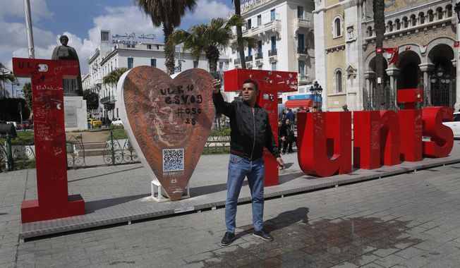 A Tunisian man takes selfie on a street in downtown Tunis, Tunisia, Thursday, March 28, 2019. Tunisia is cleaning up its boulevards and securing its borders for an Arab League summit that this country hopes raises its regional profile and economic prospects. Government ministers from the 22 Arab League states are holding preparatory meetings in Tunis all week for Sunday&#x27;s summit. (AP Photo/Hussein Malla)