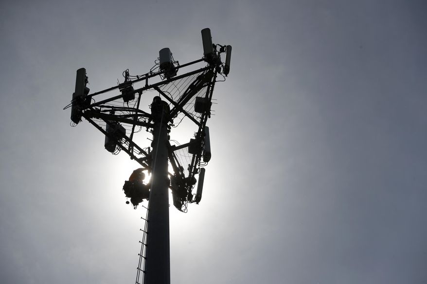FILE- In this May 22, 2017, file photo Nick Blase with True North Management Services climbs down from a cellular phone town after performing maintenance as it is silhouetted against the sky in High Ridge, Mo. The 4G speeds, what we’re used to today, made possible many of the things we now take for granted on our phones, Instagram, cloud storage, Netflix. Also, for instance, that ride you got home from the bar. (AP Photo/Jeff Roberson, File)