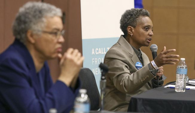 In this March 24, 2019 photo, Chicago mayoral candidate Lori Lightfoot, right, participates in a candidate forum sponsored by One Chicago For All Alliance at Daley College in Chicago. Lightfoot and Toni Preckwinkle, left, are competing to make history by becoming the city&#x27;s first black, female mayor. On issues their positions are similar. But their resumes are not, and that may make all the difference when voters pick a new mayor on Tuesday. (AP Photo/Teresa Crawford)