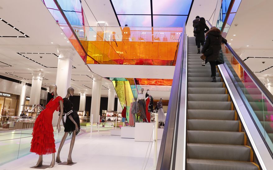 FILE- In this Feb. 20, 2019, file photo shoppers ride the escalator at Saks Fifth Avenue's flagship midtown Manhattan store in New York. On Friday, March 29, the Commerce Department issues its January report on consumer spending, which accounts for roughly 70 percent of U.S. economic activity. (AP Photo/Kathy Willens, File)