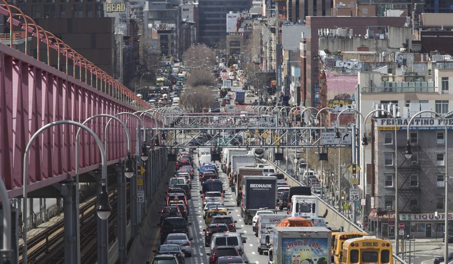 In this March 28, 2019, file photo, traffic makes its way into Manhattan from Brooklyn over the Williamsburg Bridge in New York. Long ringed by some of the most expensive toll roads in the U.S., New York City is poised to take things even further with a plan to use automated license plate readers to charge drivers who motor into the most congested parts of Manhattan during times when crosstown traffic is at its worst. (AP Photo/Mary Altaffer) ** FILE **