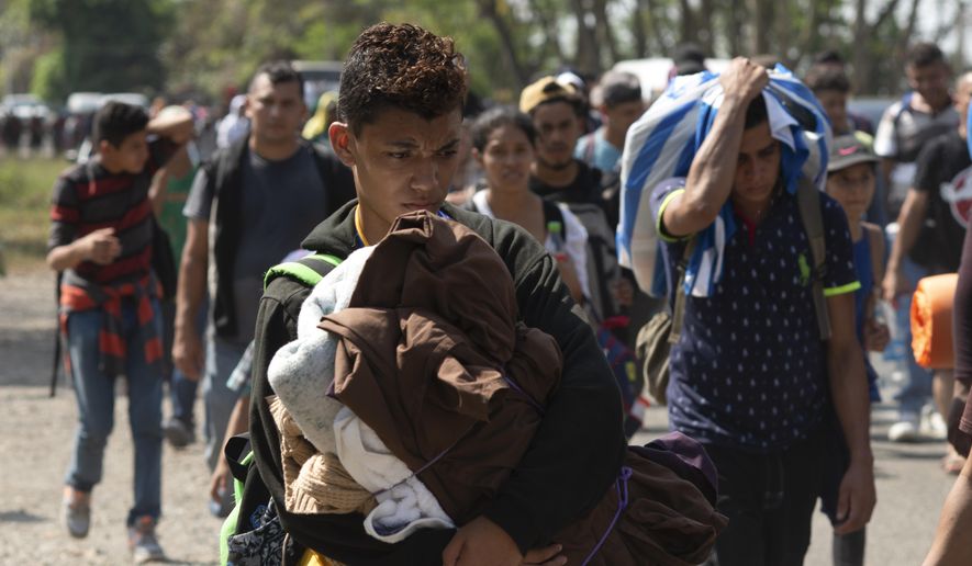 Central American migrants, part of the caravan hoping to reach the U.S. border, move on a road in Tapachula, Chiapas State, Mexico, Thursday, March 28, 2019. A caravan of about 2,500 Central Americans and Cubans is currently making its way through Mexico&#39;s southern state of Chiapas. (AP Photo/Isabel Mateos) ** FILE **