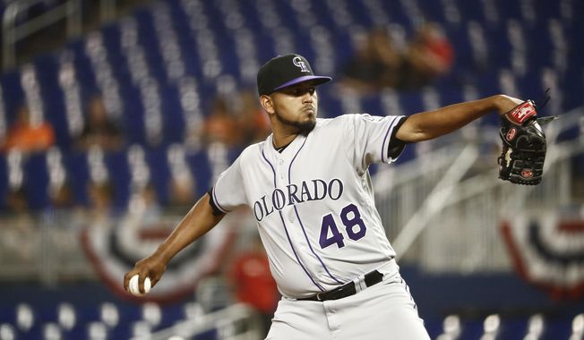 Colorado Rockies starting pitcher German Marquez delivers during the first inning of a baseball game against the Miami Marlins on Friday, March 29, 2019, in Miami. (AP Photo/Brynn Anderson)