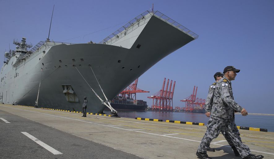 Australian naval officers walk past the HMAS Canberra, one of four Royal Australian Navy ships visiting Sri Lanka as part of defense corporation between the two countries, in Colombo, Sri Lanka, Friday, March 29, 2019. Australia says its armed forces have no qualms about working with Sri Lankan security forces accused of grave human rights violations during the country&#39;s civil war, but those allegations must be taken seriously and investigated. (AP Photo/Eranga Jayawardena)