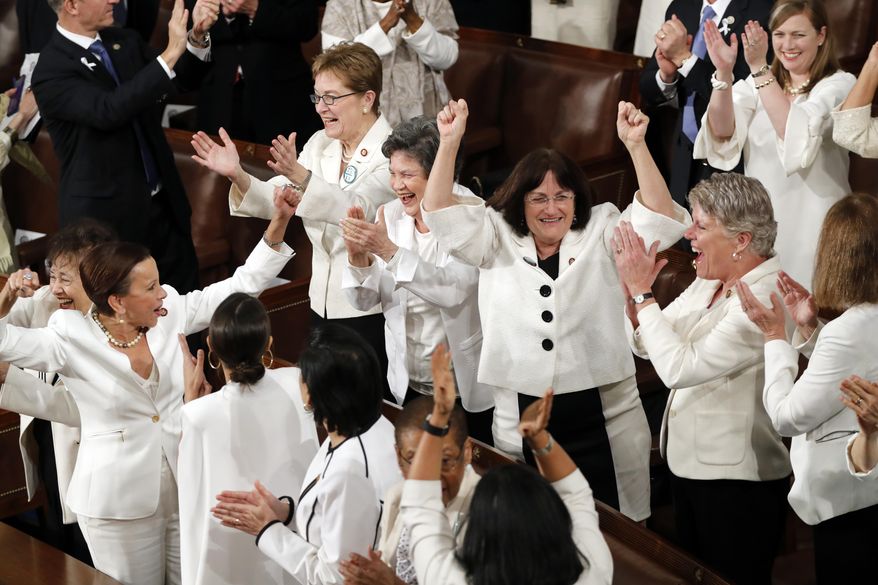 FILE - In this Feb. 5, 2019 file photo, women members of Congress cheer after President Donald Trump acknowledges more women in Congress during his State of the Union address to a joint session of Congress on Capitol Hill in Washington. A new survey finds acceptance of women in American politics and the workforce is at a record high. (AP Photo/J. Scott Applewhite)