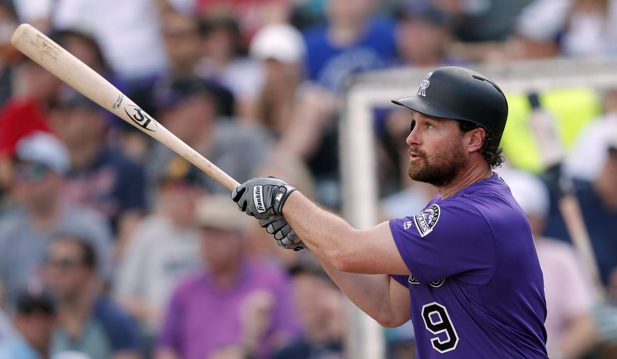 Colorado Rockies second baseman Daniel Murphy (9) follows through on a two-run home run in the first inning of a spring training baseball game against the Minnesota Twins Tuesday, March 26, 2019, in Fort Myers, Fla. (AP Photo/John Bazemore)