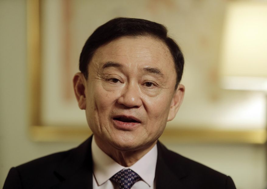 FILE - In this March 9, 2016, file photo, Thailand&#39;s former Prime Minister Thaksin Shinawatra responds to questions during a interview in New York. Thailand&#39;s king has stripped fugitive former Prime Minister Thaksin of his royal decorations, citing his 2008 flight to escape serving a two-year prison term on a conflict of interest conviction and other legal cases against him. Thai media reported that the Royal Command from King Maha Vajiralongkorn was published Saturday, March 30, 2019 in the Royal Gazette. (AP Photo/Frank Franklin II, File)