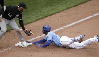 Kansas City Royals&#39; Jorge Soler beats the tag by Chicago White Sox third baseman Yoan Moncada (10) to advance to third on a throwing error by shortstop Tim Anderson after hitting a two-run double during the sixth inning of a baseball game Saturday, March 30, 2019, in Kansas City, Mo. (AP Photo/Charlie Riedel)