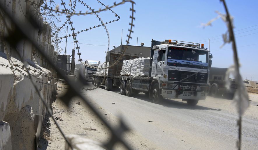 Trucks full of goods depart from the Palestinian side of the Kerem Shalom cargo crossing with Israel, in Rafah, southern Gaza Strip, Wednesday, Aug. 15, 2018. Israel on Wednesday opened its only cargo crossing with the Gaza Strip weeks after closing it amid a surge in violence with the Islamic militant group Hamas. The reopening of the Kerem Shalom crossing came as Egypt was stepping up efforts to broker a lasting cease-fire. (AP Photo/Adel Hana)