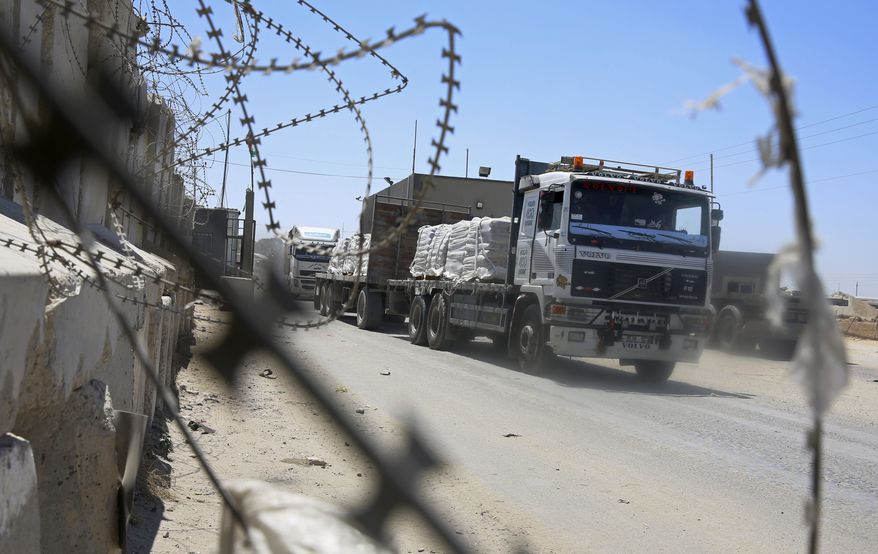 Trucks full of goods depart from the Palestinian side of the Kerem Shalom cargo crossing with Israel, in Rafah, southern Gaza Strip, Wednesday, Aug. 15, 2018. Israel on Wednesday opened its only cargo crossing with the Gaza Strip weeks after closing it amid a surge in violence with the Islamic militant group Hamas. The reopening of the Kerem Shalom crossing came as Egypt was stepping up efforts to broker a lasting cease-fire. (AP Photo/Adel Hana)