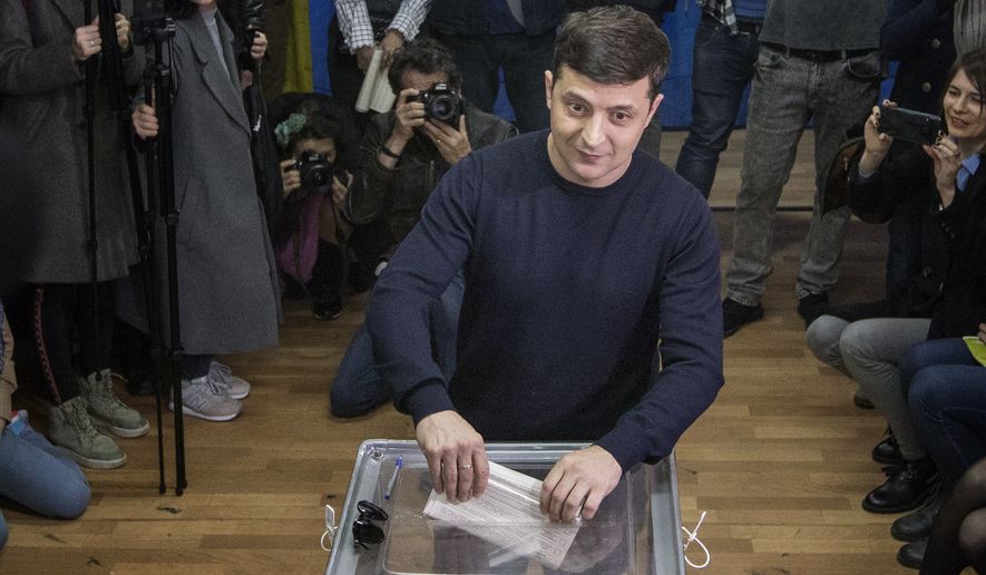 Ukrainian comedian and presidential candidate Volodymyr Zelenskiy casts his ballot at a polling station, during the presidential elections in Kiev, Ukraine, Sunday, March. 31, 2019. (AP Photo/Emilio Morenatti)