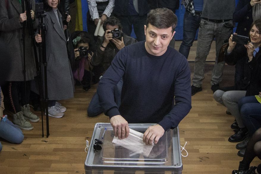 Ukrainian comedian and presidential candidate Volodymyr Zelenskiy casts his ballot at a polling station, during the presidential elections in Kiev, Ukraine, Sunday, March. 31, 2019. (AP Photo/Emilio Morenatti)