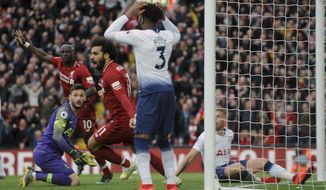 Liverpool&#39;s Mohamed Salah, center, celebrates after Tottenham&#39;s Toby Alderweireld scores an own goal past his goalkeeper during the English Premier League soccer match between Liverpool and Tottenham Hotspur at Anfield stadium in Liverpool, England, Sunday, March 31, 2019. (AP Photo/Rui Vieira)