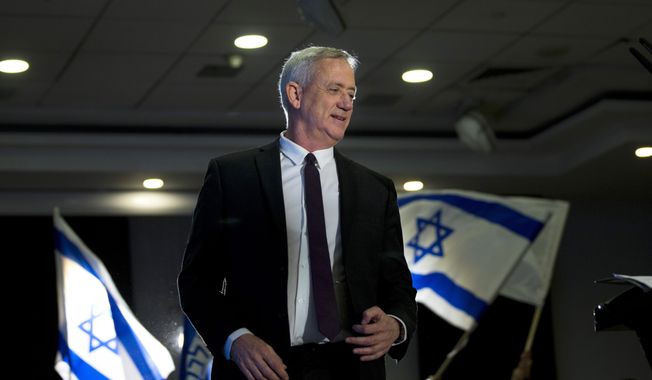 FILE - In this Wednesday, March 27, 2019 file photo, retired Israeli general Benny Gantz, one of the leaders of the Blue and White party, prepares to deliver a speech during election campaigning for elections to be held April 9, in Ramat Gan, Israel. Down in the polls, Israeli Prime Minister Benjamin Netanyahu’s Likud Party has released a new campaign trying to paint Gantz, his main rival, as mentally unstable. The video ads are the latest move in a campaign that has been heavy on personal insults and short on substance. (AP Photo/Oded Balilty, File)