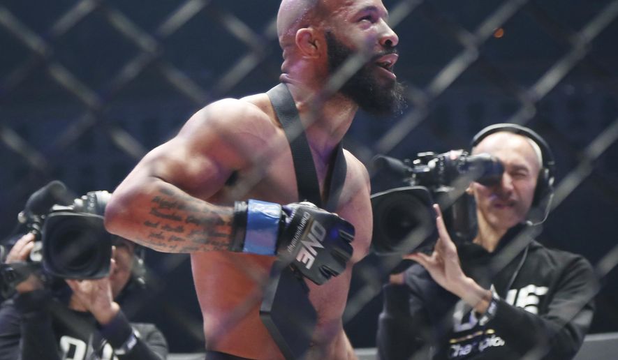 Mixed martial arts (MMA) fighters Demetrious Johnson of the United States celebrates after defeating Japan&#39;s Yuya Wakamatsu during their flyweight world grand prix quarterfinal of One Championship bout in Tokyo, Sunday, March 31, 2019. (AP Photo/Koji Sasahara)
