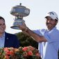 Kevin Kisner, right, holds his trophy presented by Michael Dell, CEO of Dell Technologies, after he defeated Matt Kuchar in the finals at the Dell Technologies Match Play Championship golf tournament, Sunday, March 31, 2019, in Austin, Texas. (AP Photo/Eric Gay)
