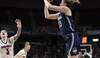 Louisville forward Sam Fuehring (3)defends as Connecticut guard Katie Lou Samuelson (33)shoots from the perimeter during the first half of a regional championship final in the NCAA women&#x27;s college basketball tournament, Sunday, March 31, 2019, in Albany, N.Y. (AP Photo/Kathy Willens)