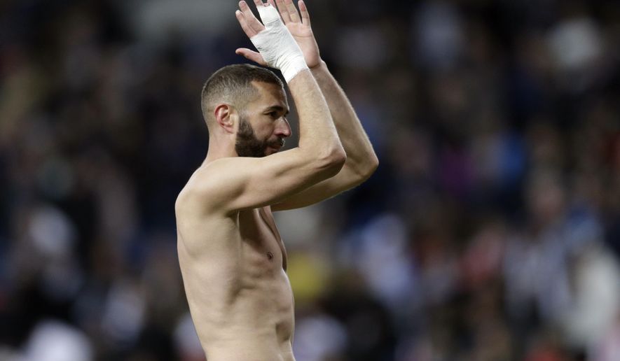 Real Madrid&#39;s Karim Benzema applauds the fans at the end of a Spanish La Liga soccer match between Real Madrid and Huesca at the Santiago Bernabeu stadium in Madrid, Sunday, March 31, 2019. Benzema scored the third goal in Real Madrid&#39;s 3-2 win. (AP Photo/Bernat Armangue)