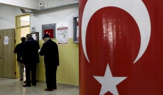 Voters wait in the line for cast their ballots at a polling station during the local elections in Ankara, Turkey, Sunday, March 31, 2019. Turkish citizens have begun casting votes in municipal elections for mayors, local assembly representatives and neighborhood or village administrators that are seen as a barometer of Erdogan&#39;s popularity amid a sharp economic downturn. (AP Photo/Ali Unal)
